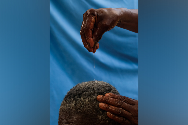 Oiling hair by Biko Wesa, Participant of World Coconut Day 2021 Competition